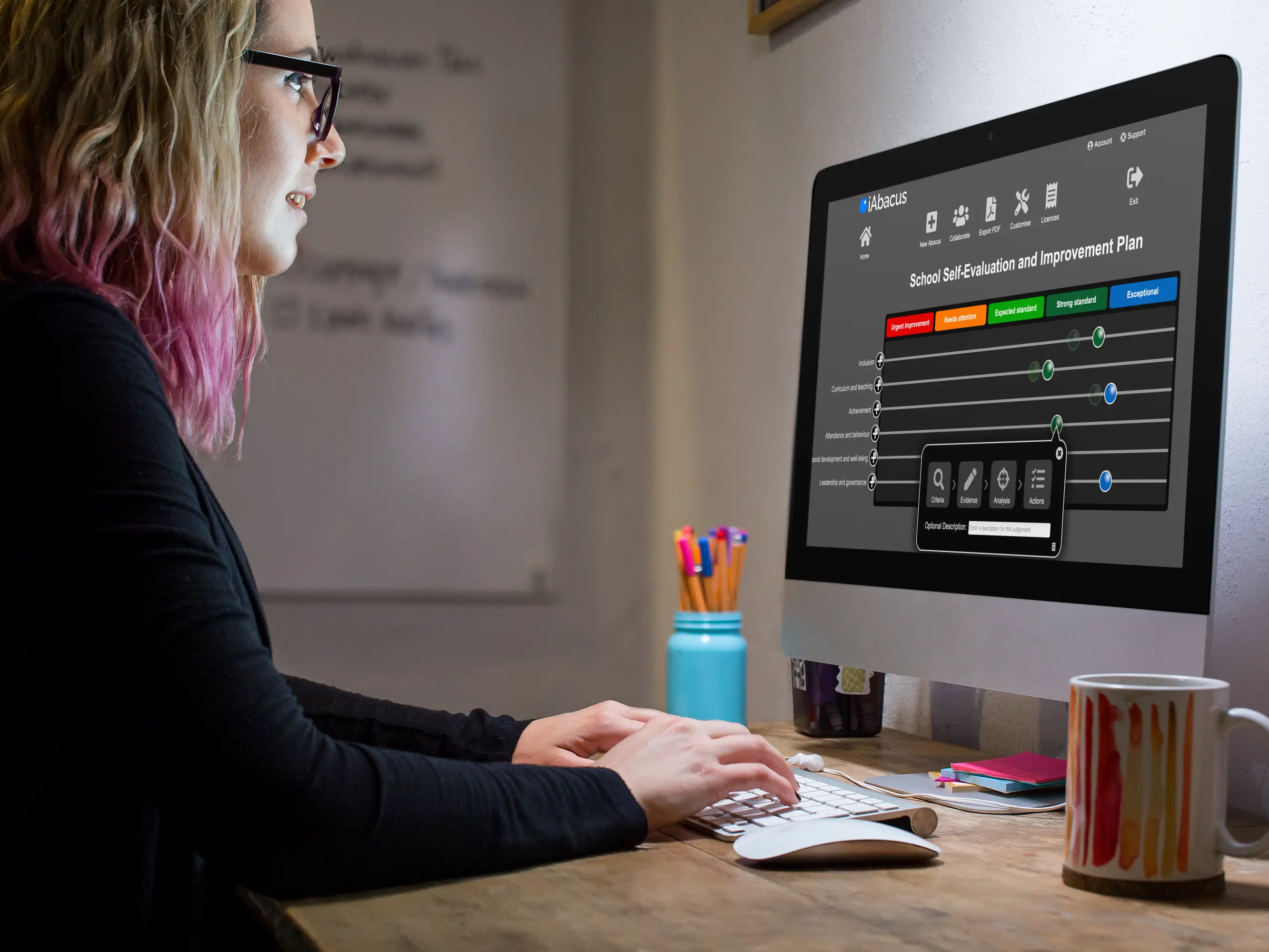 A confident headteacher reviewing the iAbacus Report Card Dashboard on screen